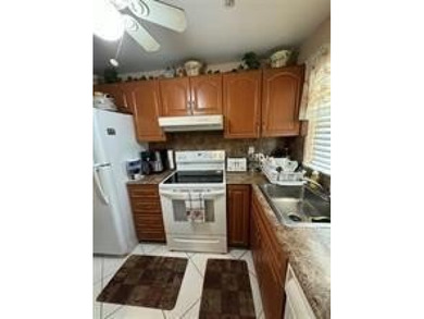 Two-bedroom, two-bathroom corner unit in the second floor in the on Sunrise Lakes Phase III in Florida - for sale on GolfHomes.com, golf home, golf lot