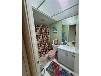 Two-bedroom, two-bathroom corner unit in the second floor in the on Sunrise Lakes Phase III in Florida - for sale on GolfHomes.com, golf home, golf lot