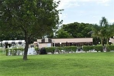 Two-bedroom, two-bathroom corner unit in the second floor in the on Sunrise Lakes Phase III in Florida - for sale on GolfHomes.com, golf home, golf lot