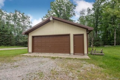 Nestled in the gated community of Lost Lake Woods Club in on Lost Lake Woods Club in Michigan - for sale on GolfHomes.com, golf home, golf lot