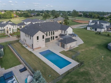 Welcome to a glorious modern residence nestled behind the gates on Oak Tree National Golf and Country Club in Oklahoma - for sale on GolfHomes.com, golf home, golf lot