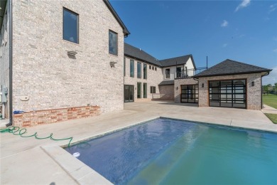 Welcome to a glorious modern residence nestled behind the gates on Oak Tree National Golf and Country Club in Oklahoma - for sale on GolfHomes.com, golf home, golf lot