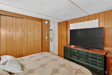 THIS CHARMING 2-bedroom, 2-bath mobile home is nestled in the on Bay Tree Golf Course in Florida - for sale on GolfHomes.com, golf home, golf lot