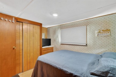 THIS CHARMING 2-bedroom, 2-bath mobile home is nestled in the on Bay Tree Golf Course in Florida - for sale on GolfHomes.com, golf home, golf lot