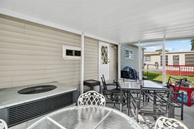 THIS CHARMING 2-bedroom, 2-bath mobile home is nestled in the on Bay Tree Golf Course in Florida - for sale on GolfHomes.com, golf home, golf lot