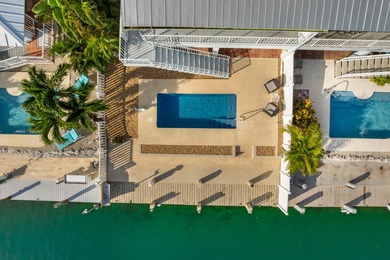 Welcome to this inviting east facing, waterfront, stilted half on Key Colony Beach Golf Course in Florida - for sale on GolfHomes.com, golf home, golf lot