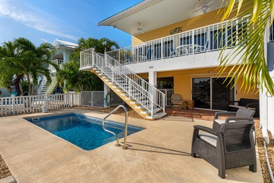 Welcome to this inviting east facing, waterfront, stilted half on Key Colony Beach Golf Course in Florida - for sale on GolfHomes.com, golf home, golf lot