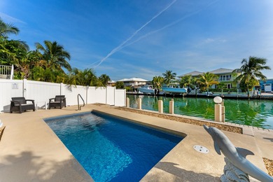 Welcome to this inviting east facing, waterfront, stilted half on Key Colony Beach Golf Course in Florida - for sale on GolfHomes.com, golf home, golf lot
