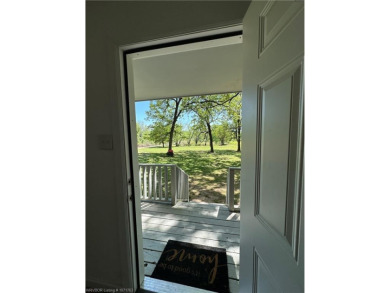 Begin your morning with a cup of coffee and take in the scenery on Vache-Grasse Country Club in Arkansas - for sale on GolfHomes.com, golf home, golf lot