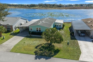 Wake up every day to peaceful water views and easy Florida on Plantation Golf Club in Florida - for sale on GolfHomes.com, golf home, golf lot