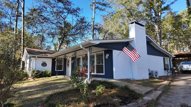 Beautiful home perched on a hill overlooking a scenic view of on Hide-A-Way Lake Golf Course in Texas - for sale on GolfHomes.com, golf home, golf lot