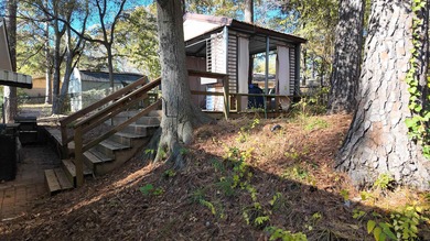 Beautiful home perched on a hill overlooking a scenic view of on Hide-A-Way Lake Golf Course in Texas - for sale on GolfHomes.com, golf home, golf lot