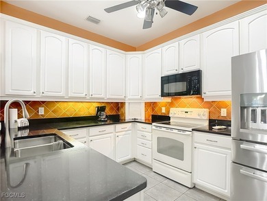 This sunny END UNIT attached villa in HERONS GLEN COUNTRY CLUB's on Herons Glen Golf and Country Club in Florida - for sale on GolfHomes.com, golf home, golf lot