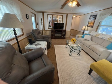 Beautifully furnished 2 bedroom, 2 bath home featuring a on Lake Henry Golf Club in Florida - for sale on GolfHomes.com, golf home, golf lot