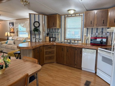 Beautifully furnished 2 bedroom, 2 bath home featuring a on Lake Henry Golf Club in Florida - for sale on GolfHomes.com, golf home, golf lot