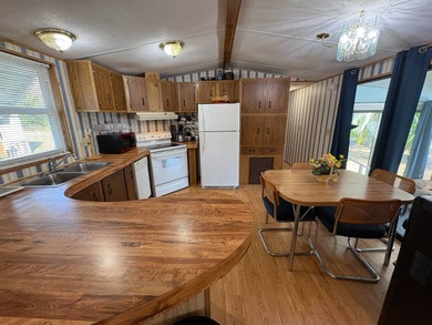 Beautifully furnished 2 bedroom, 2 bath home featuring a on Lake Henry Golf Club in Florida - for sale on GolfHomes.com, golf home, golf lot