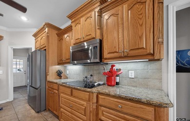 This beautifully maintained 4-bedroom, 2-bath traditional brick on Hide-A-Way Lake Golf Course in Texas - for sale on GolfHomes.com, golf home, golf lot