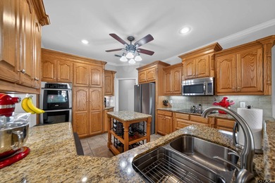 This beautifully maintained 4-bedroom, 2-bath traditional brick on Hide-A-Way Lake Golf Course in Texas - for sale on GolfHomes.com, golf home, golf lot