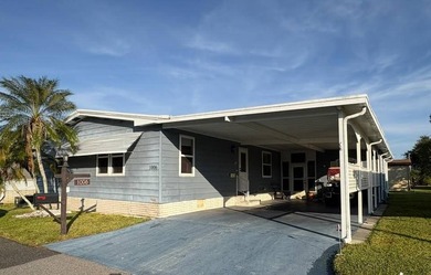 Step into this stunning furnished 3-bedroom, 2-bath home with a on Lake Henry Golf Club in Florida - for sale on GolfHomes.com, golf home, golf lot