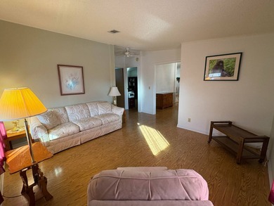 Step into this stunning furnished 3-bedroom, 2-bath home with a on Lake Henry Golf Club in Florida - for sale on GolfHomes.com, golf home, golf lot