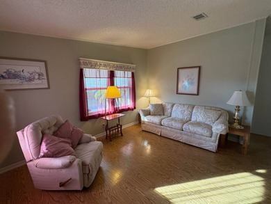 Step into this stunning furnished 3-bedroom, 2-bath home with a on Lake Henry Golf Club in Florida - for sale on GolfHomes.com, golf home, golf lot