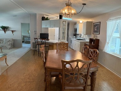 Step into this stunning furnished 3-bedroom, 2-bath home with a on Lake Henry Golf Club in Florida - for sale on GolfHomes.com, golf home, golf lot