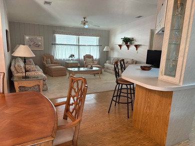 Step into this stunning furnished 3-bedroom, 2-bath home with a on Lake Henry Golf Club in Florida - for sale on GolfHomes.com, golf home, golf lot