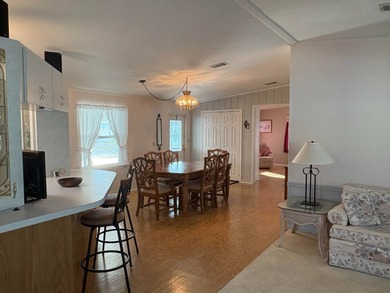 Step into this stunning furnished 3-bedroom, 2-bath home with a on Lake Henry Golf Club in Florida - for sale on GolfHomes.com, golf home, golf lot