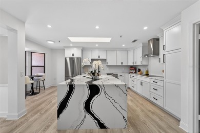 Situated behind gates of the coveted Bay Isles on Longboat Key on Longboat Key Golf Club Resort in Florida - for sale on GolfHomes.com, golf home, golf lot