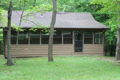Check out this charming, cozy cabin w/ a fantastic corner lot on Hide-A-Way Hills Golf Club in Ohio - for sale on GolfHomes.com, golf home, golf lot