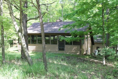 Check out this charming, cozy cabin w/ a fantastic corner lot on Hide-A-Way Hills Golf Club in Ohio - for sale on GolfHomes.com, golf home, golf lot