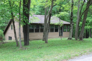 Check out this charming, cozy cabin w/ a fantastic corner lot on Hide-A-Way Hills Golf Club in Ohio - for sale on GolfHomes.com, golf home, golf lot