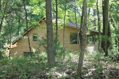 Check out this charming, cozy cabin w/ a fantastic corner lot on Hide-A-Way Hills Golf Club in Ohio - for sale on GolfHomes.com, golf home, golf lot