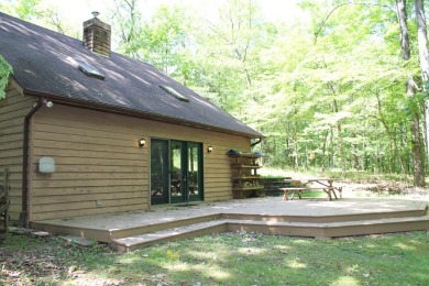 Check out this charming, cozy cabin w/ a fantastic corner lot on Hide-A-Way Hills Golf Club in Ohio - for sale on GolfHomes.com, golf home, golf lot