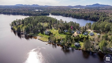 Discover the charm of this immaculate historic cottage at Upper on Saranac Inn Golf and Country Club in New York - for sale on GolfHomes.com, golf home, golf lot