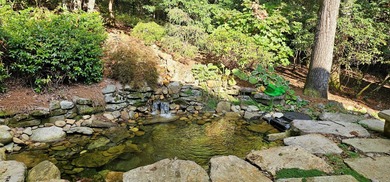 This stunning home sits on a private 2.45 ac. lot with lots of on Lake Toxaway Country Club in North Carolina - for sale on GolfHomes.com, golf home, golf lot