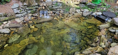 This stunning home sits on a private 2.45 ac. lot with lots of on Lake Toxaway Country Club in North Carolina - for sale on GolfHomes.com, golf home, golf lot