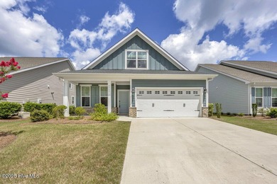 Discover the charm of low-maintenance living in this beautifully on Cape Fear National At Brunswick Forest in North Carolina - for sale on GolfHomes.com, golf home, golf lot
