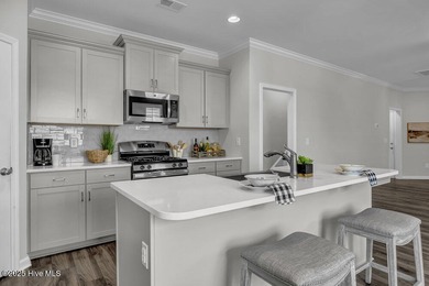 Discover the charm of low-maintenance living in this beautifully on Cape Fear National At Brunswick Forest in North Carolina - for sale on GolfHomes.com, golf home, golf lot