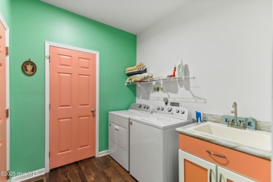 Welcome to this charming 2-bedroom, 2-bath home located just a on Oyster Bay Golf Links in North Carolina - for sale on GolfHomes.com, golf home, golf lot