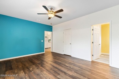 Welcome to this charming 2-bedroom, 2-bath home located just a on Oyster Bay Golf Links in North Carolina - for sale on GolfHomes.com, golf home, golf lot