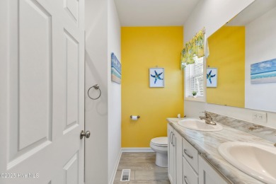 Welcome to this charming 2-bedroom, 2-bath home located just a on Oyster Bay Golf Links in North Carolina - for sale on GolfHomes.com, golf home, golf lot