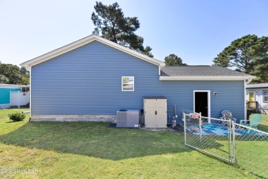 Welcome to this charming 2-bedroom, 2-bath home located just a on Oyster Bay Golf Links in North Carolina - for sale on GolfHomes.com, golf home, golf lot