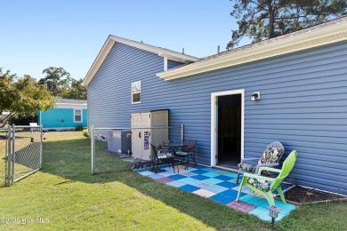 Welcome to this charming 2-bedroom, 2-bath home located just a on Oyster Bay Golf Links in North Carolina - for sale on GolfHomes.com, golf home, golf lot