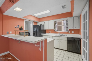 Savor the Florida lifestyle in this charming three-bedroom pool on Daytona Beach Golf Club in Florida - for sale on GolfHomes.com, golf home, golf lot