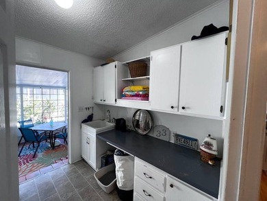 Beautifully maintained 2-bedroom, 2-bath home offering comfort on Lake Henry Golf Club in Florida - for sale on GolfHomes.com, golf home, golf lot