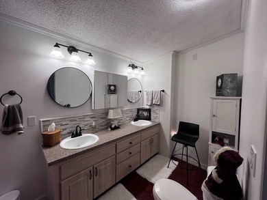 Beautifully maintained 2-bedroom, 2-bath home offering comfort on Lake Henry Golf Club in Florida - for sale on GolfHomes.com, golf home, golf lot