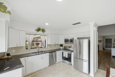 Discover this two-bedroom, two-bath end unit in Quail Meadows at on Martin Downs Country Club in Florida - for sale on GolfHomes.com, golf home, golf lot