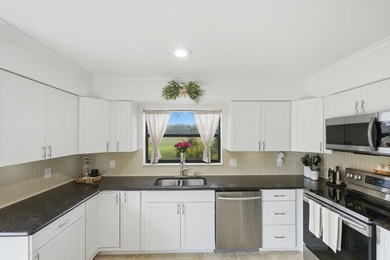 Discover this two-bedroom, two-bath end unit in Quail Meadows at on Martin Downs Country Club in Florida - for sale on GolfHomes.com, golf home, golf lot