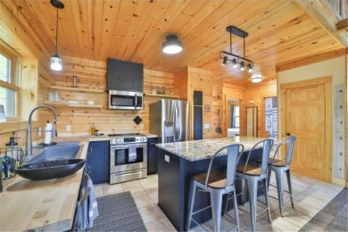 Enjoy relaxing on the large 10x30 deck overlooking the 11th hole on Hardwoods Golf Club At Mille Lacs in Minnesota - for sale on GolfHomes.com, golf home, golf lot